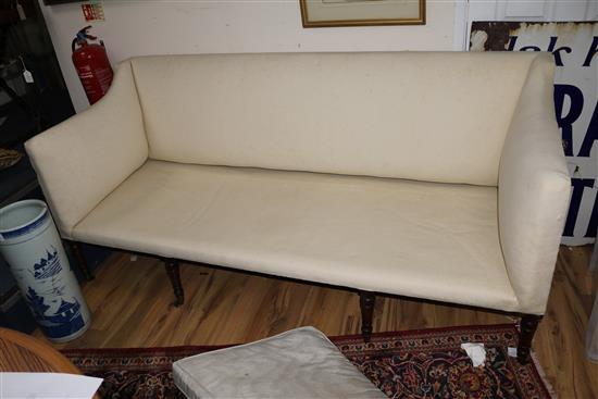 A Regency mahogany settee, with ring turned tapered legs W.196cm